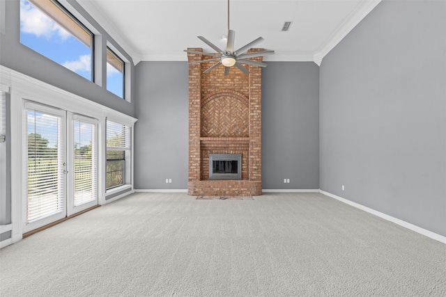 4223 Mojave Dr, Granbury, TX 76049 - unfurnished living room with a ceiling fan, crown molding, a brick fireplace, carpet flooring, and a towering ceiling