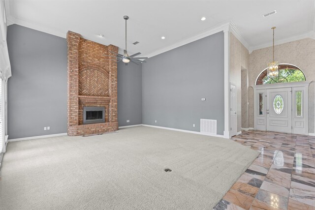 4223 Mojave Dr, Granbury, TX 76049 - unfurnished living room with a ceiling fan, a towering ceiling, ornamental molding, marble tiled floors, and a brick fireplace