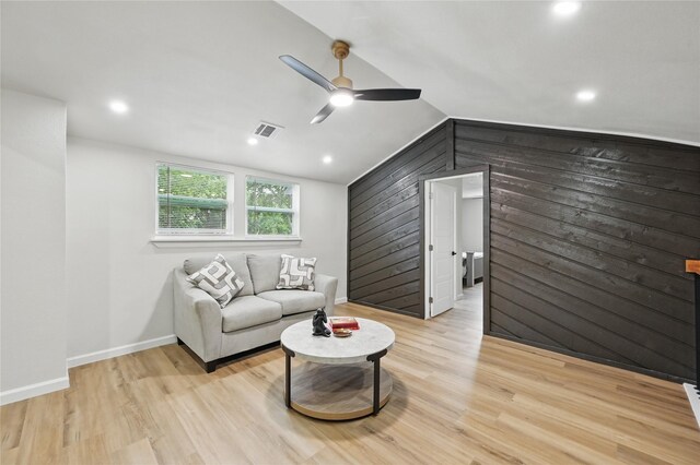 9690 Fallbrook Dr, Dallas, TX 75243 - living room with a ceiling fan, lofted ceiling, light wood-style flooring, wood walls, and baseboards