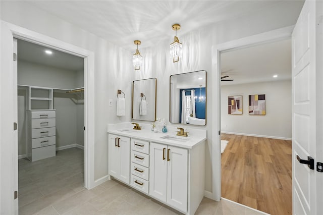 9690 Fallbrook Dr, Dallas, TX 75243 - full bath featuring double vanity, a spacious closet, baseboards, ceiling fan, and recessed lighting