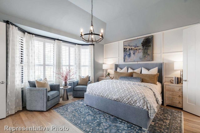 11749 Edgewood Dr, Justin, TX 76247 - bedroom with a chandelier, wood finished floors, and vaulted ceiling
