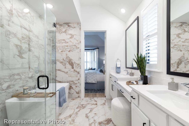 11749 Edgewood Dr, Justin, TX 76247 - ensuite bathroom with marble finish floors, a stall shower, two vanities, a freestanding tub, and tile walls