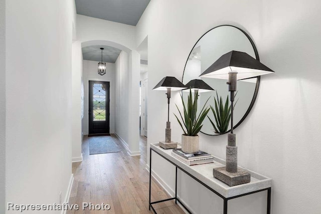 11749 Edgewood Dr, Justin, TX 76247 - foyer entrance featuring arched walkways, light wood finished floors, and baseboards