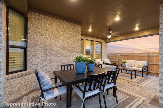 11749 Edgewood Dr, Justin, TX 76247 - patio terrace at dusk with an outdoor living space, a patio area, a ceiling fan, and outdoor dining space
