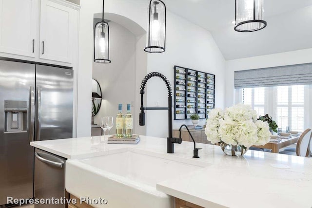 11749 Edgewood Dr, Justin, TX 76247 - kitchen featuring a sink, stainless steel fridge with ice dispenser, vaulted ceiling, white cabinetry, and light stone counters