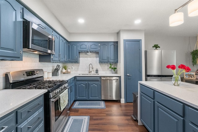 2937 Lake Park Dr, Grand Prairie, TX 75052 - kitchen featuring stainless steel appliances, a sink, light countertops, tasteful backsplash, and dark wood-style floors