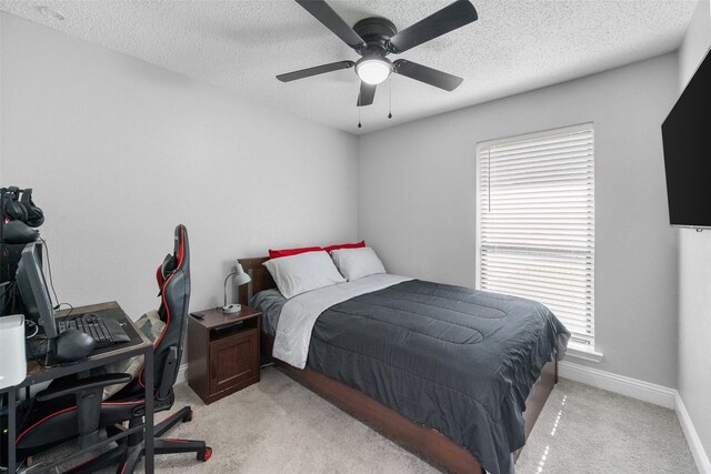 2937 Lake Park Dr, Grand Prairie, TX 75052 - bedroom with a desk, light carpet, a textured ceiling, baseboards, and a ceiling fan