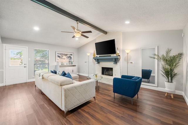 2937 Lake Park Dr, Grand Prairie, TX 75052 - living area featuring wood finished floors, a fireplace, a textured ceiling, ceiling fan, and baseboards