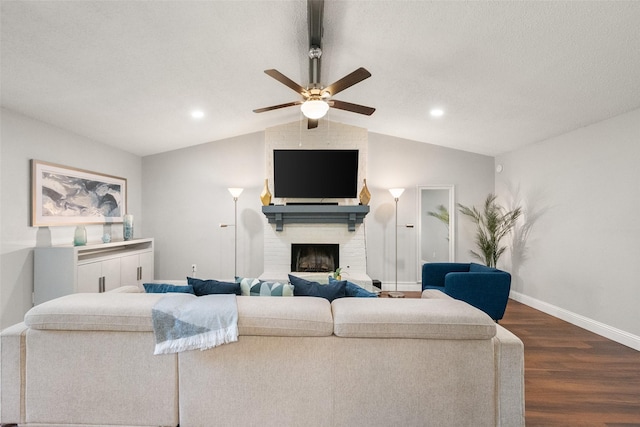 2937 Lake Park Dr, Grand Prairie, TX 75052 - living room with dark wood-type flooring, vaulted ceiling, baseboards, ceiling fan, and a fireplace