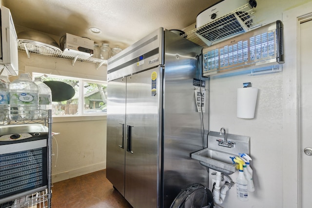 8700 Fm 920, Peaster, TX 76088 - kitchen with high quality fridge, concrete floors, baseboards, a sink, and a textured ceiling