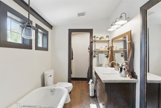 8700 Fm 920, Peaster, TX 76088 - full bathroom featuring a freestanding tub, toilet, vanity, wood finished floors, and vaulted ceiling