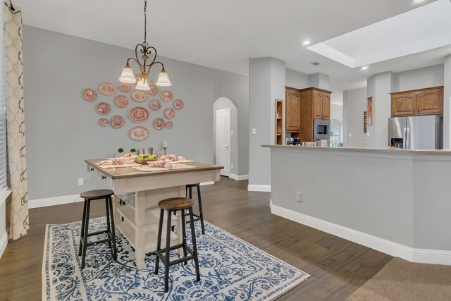 6504 Bluebird Dr, Arlington, TX 76001 - dining space featuring arched walkways, dark wood-type flooring, baseboards, recessed lighting, and a chandelier