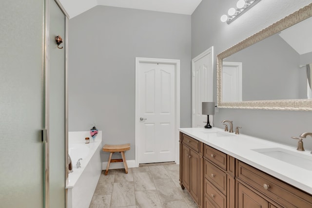 6504 Bluebird Dr, Arlington, TX 76001 - bathroom featuring a garden tub, double vanity, and lofted ceiling
