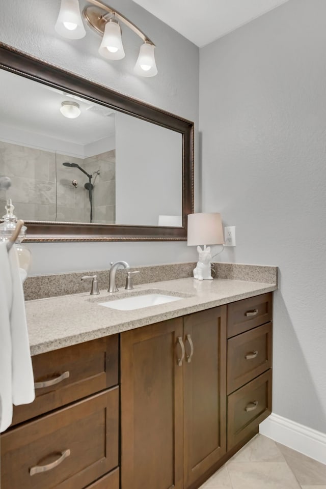 6504 Bluebird Dr, Arlington, TX 76001 - bathroom with vanity, tiled shower, and baseboards