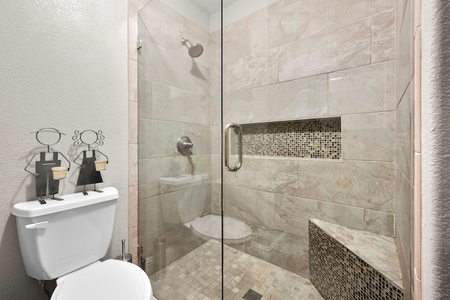 6504 Bluebird Dr, Arlington, TX 76001 - bathroom featuring toilet, a shower stall, and a textured wall