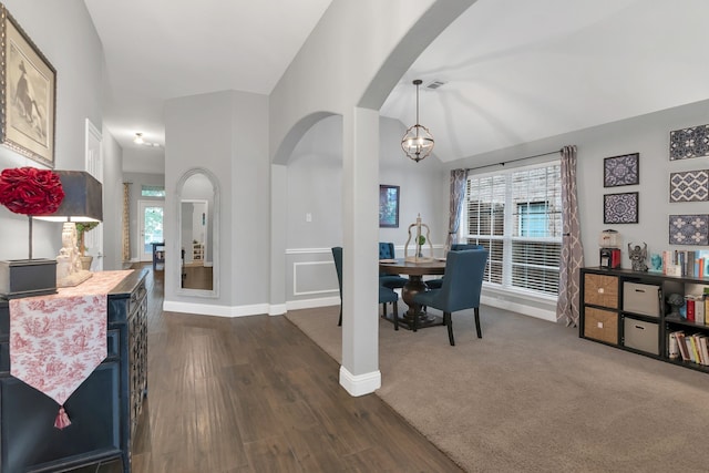 6504 Bluebird Dr, Arlington, TX 76001 - dining area featuring arched walkways, a chandelier, baseboards, and dark wood finished floors