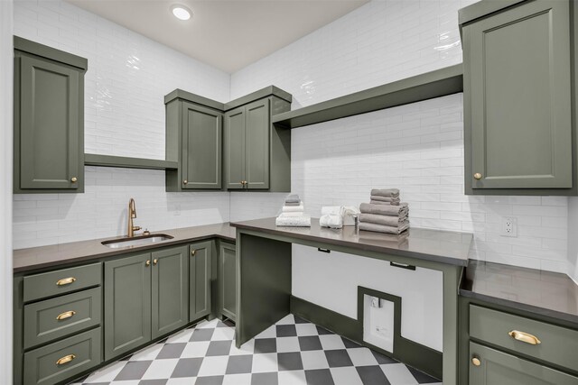 206 Laila Ct, Colleyville, TX 76034 - kitchen featuring green cabinets, a sink, light flooring, and decorative backsplash