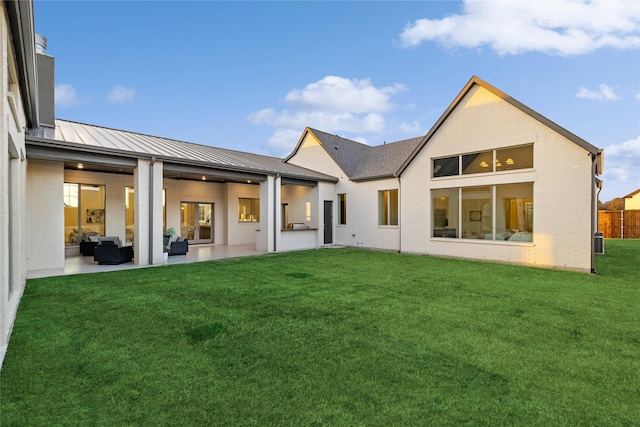 206 Laila Ct, Colleyville, TX 76034 - rear view of house with outdoor lounge area, a standing seam roof, brick siding, a lawn, and a patio