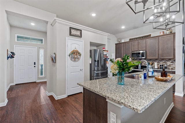 3224 Risinger Rd, Waco, TX 76655 - kitchen with appliances with stainless steel finishes, a sink, light stone countertops, dark brown cabinets, and recessed lighting