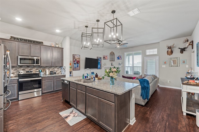 3224 Risinger Rd, Waco, TX 76655 - kitchen with appliances with stainless steel finishes, a sink, dark wood-type flooring, open floor plan, and dark brown cabinets