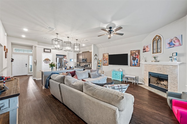 3224 Risinger Rd, Waco, TX 76655 - living room with dark wood finished floors, ceiling fan, a fireplace with flush hearth, recessed lighting, and baseboards