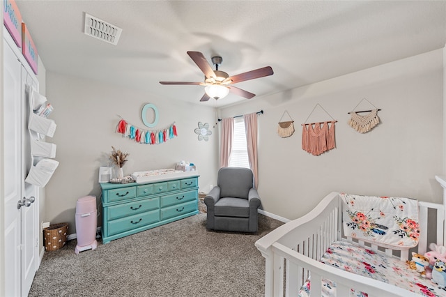 3224 Risinger Rd, Waco, TX 76655 - bedroom with a crib, carpet, and ceiling fan