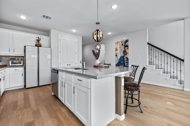 3140 Chinese Fir Dr, Heath, TX 75126 - kitchen with freestanding refrigerator, a sink, light wood-style flooring, dark countertops, and recessed lighting