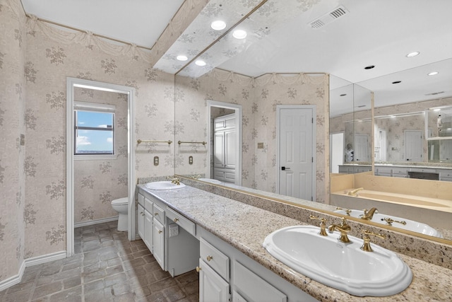 616 Crowley Rd, Arlington, TX 76012 - full bathroom with double vanity, toilet, a bath, recessed lighting, and baseboards