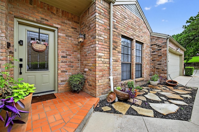 616 Crowley Rd, Arlington, TX 76012 - view of exterior entry with brick siding, a garage, and driveway