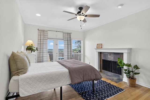 616 Crowley Rd, Arlington, TX 76012 - bedroom featuring french doors, access to exterior, wood finished floors, baseboards, and a tiled fireplace