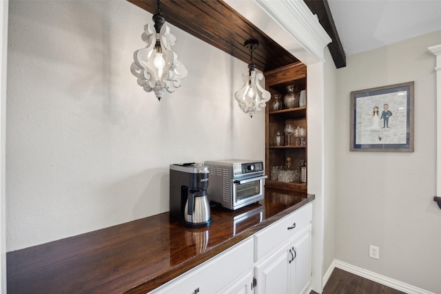 7101 Odell Ave, Rockwall, TX 75087 - bar area with dark wood-style flooring and baseboards