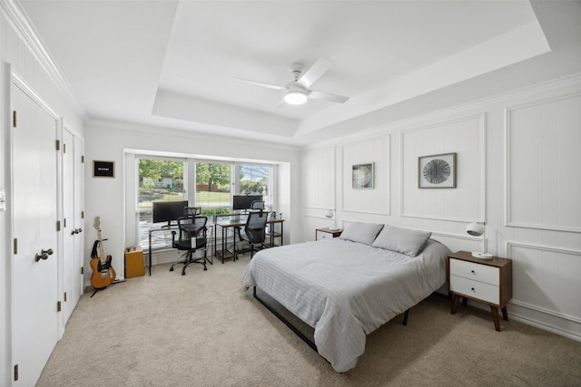 7101 Odell Ave, Rockwall, TX 75087 - bedroom featuring a tray ceiling, carpet flooring, a desk, a decorative wall, and ceiling fan