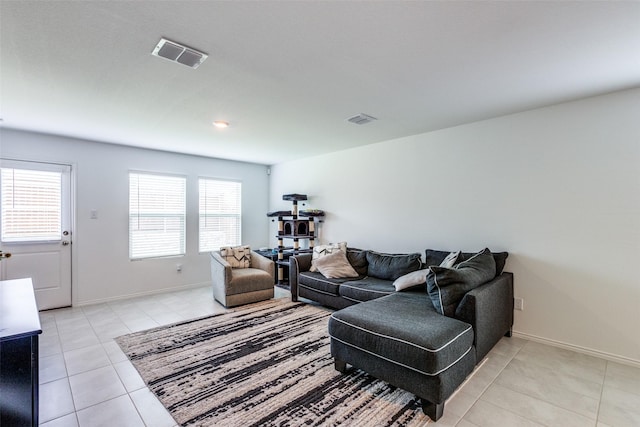 14069 Drover St, Pilot Point, TX 76258 - living area featuring light tile patterned flooring, plenty of natural light, and baseboards