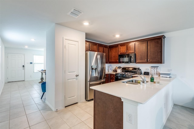14069 Drover St, Pilot Point, TX 76258 - kitchen with black appliances, a sink, a peninsula, light countertops, and light tile patterned floors
