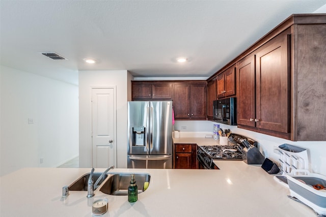14069 Drover St, Pilot Point, TX 76258 - kitchen with black appliances, light countertops, dark brown cabinets, a sink, and recessed lighting
