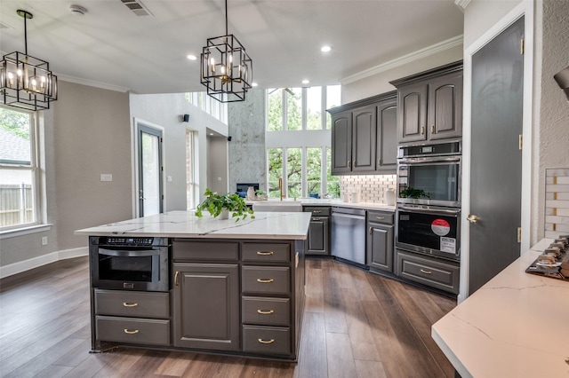 2007 Hill Country Ct, Arlington, TX 76012 - kitchen featuring a chandelier, stainless steel appliances, crown molding, healthy amount of natural light, and light stone countertops