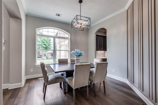 2007 Hill Country Ct, Arlington, TX 76012 - dining space with ornamental molding, dark wood-style flooring, arched walkways, a chandelier, and baseboards