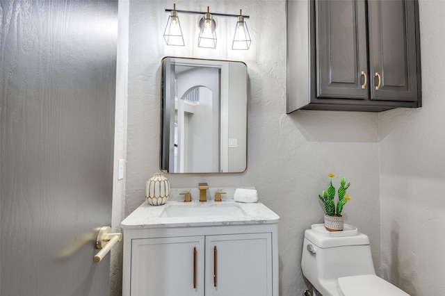 2007 Hill Country Ct, Arlington, TX 76012 - half bath with toilet, vanity, and a textured wall