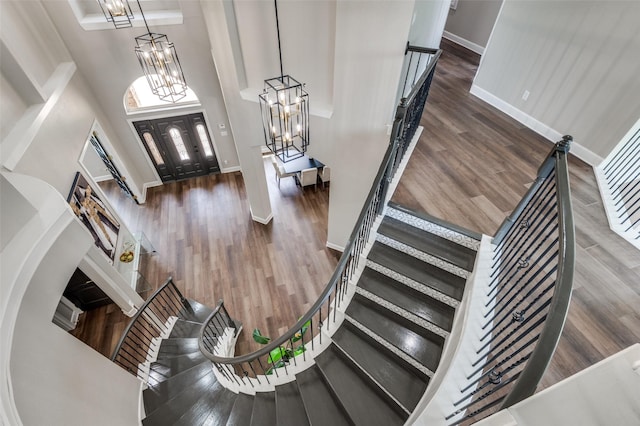 2007 Hill Country Ct, Arlington, TX 76012 - foyer entrance featuring a chandelier, baseboards, stairs, a towering ceiling, and wood finished floors