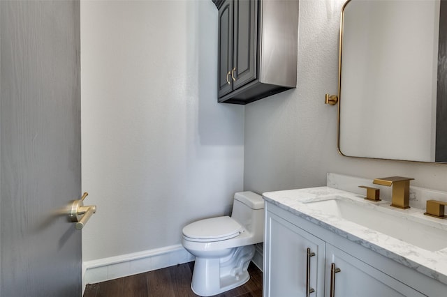 2007 Hill Country Ct, Arlington, TX 76012 - bathroom featuring toilet, vanity, wood finished floors, and baseboards