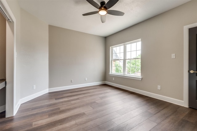 2007 Hill Country Ct, Arlington, TX 76012 - spare room with a ceiling fan, dark wood-type flooring, and baseboards