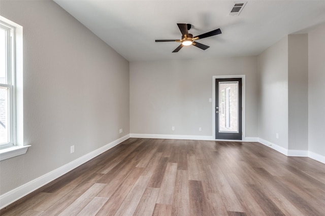 2007 Hill Country Ct, Arlington, TX 76012 - unfurnished room featuring healthy amount of natural light, wood finished floors, and a ceiling fan