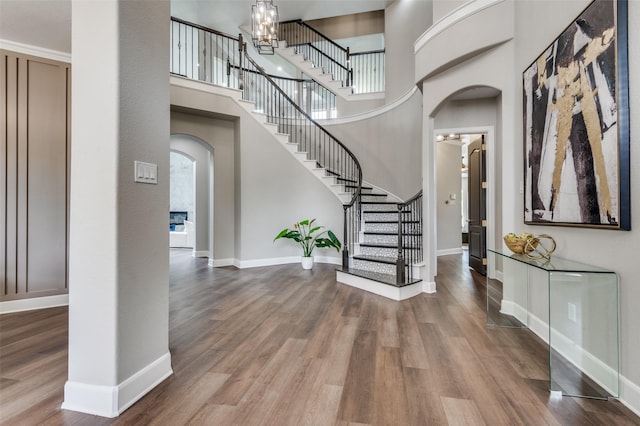 2007 Hill Country Ct, Arlington, TX 76012 - foyer featuring arched walkways, wood finished floors, baseboards, stairs, and a high ceiling
