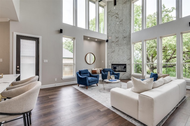 2007 Hill Country Ct, Arlington, TX 76012 - living room featuring a high ceiling, a high end fireplace, dark wood-style flooring, and baseboards