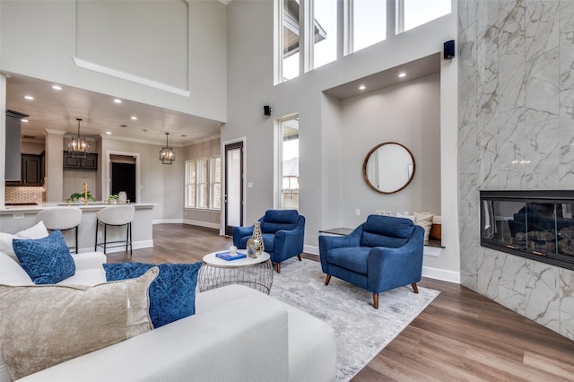 2007 Hill Country Ct, Arlington, TX 76012 - living room with a towering ceiling, wood finished floors, a high end fireplace, recessed lighting, and a chandelier