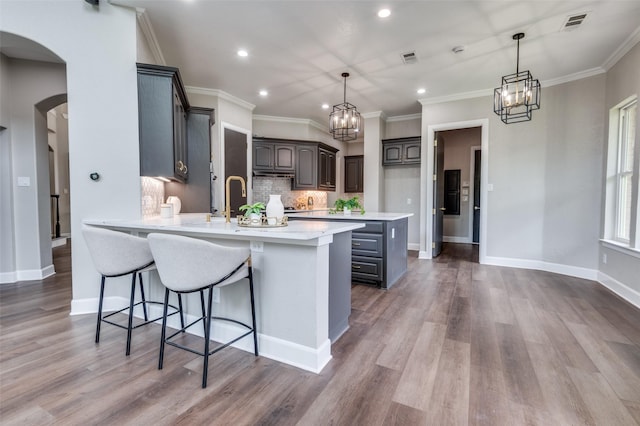 2007 Hill Country Ct, Arlington, TX 76012 - kitchen with a peninsula, arched walkways, light countertops, tasteful backsplash, and recessed lighting