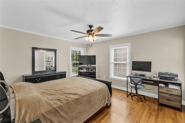 4113 Crestview Dr, Fort Worth, TX 76103 - bedroom featuring baseboards, hardwood / wood-style floors, a desk, a ceiling fan, and crown molding