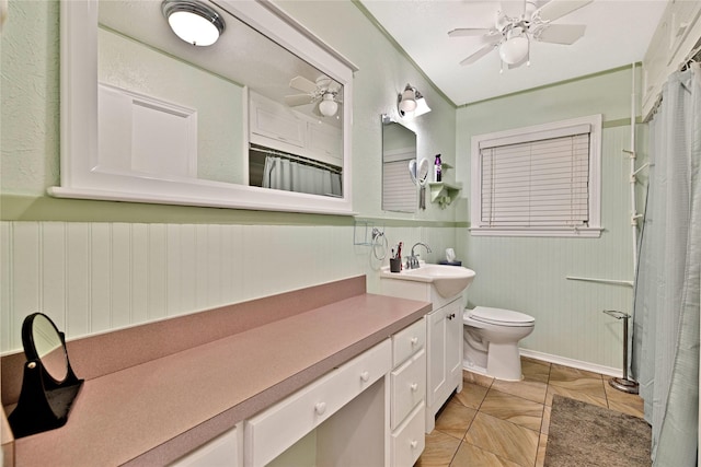 4113 Crestview Dr, Fort Worth, TX 76103 - bathroom with vanity, a wainscoted wall, a ceiling fan, toilet, and curtained shower
