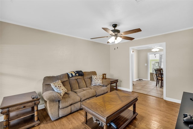 4113 Crestview Dr, Fort Worth, TX 76103 - living area featuring a ceiling fan, ornamental molding, baseboards, and light wood-style flooring