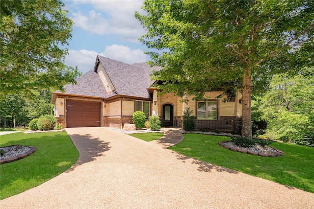 4010 Falls Creek Dr, Longview, TX 75605 - view of front of property featuring brick siding, an attached garage, a front yard, roof with shingles, and driveway